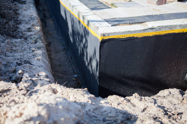 Professional Basement Waterproofing technician working in Marilla, NY